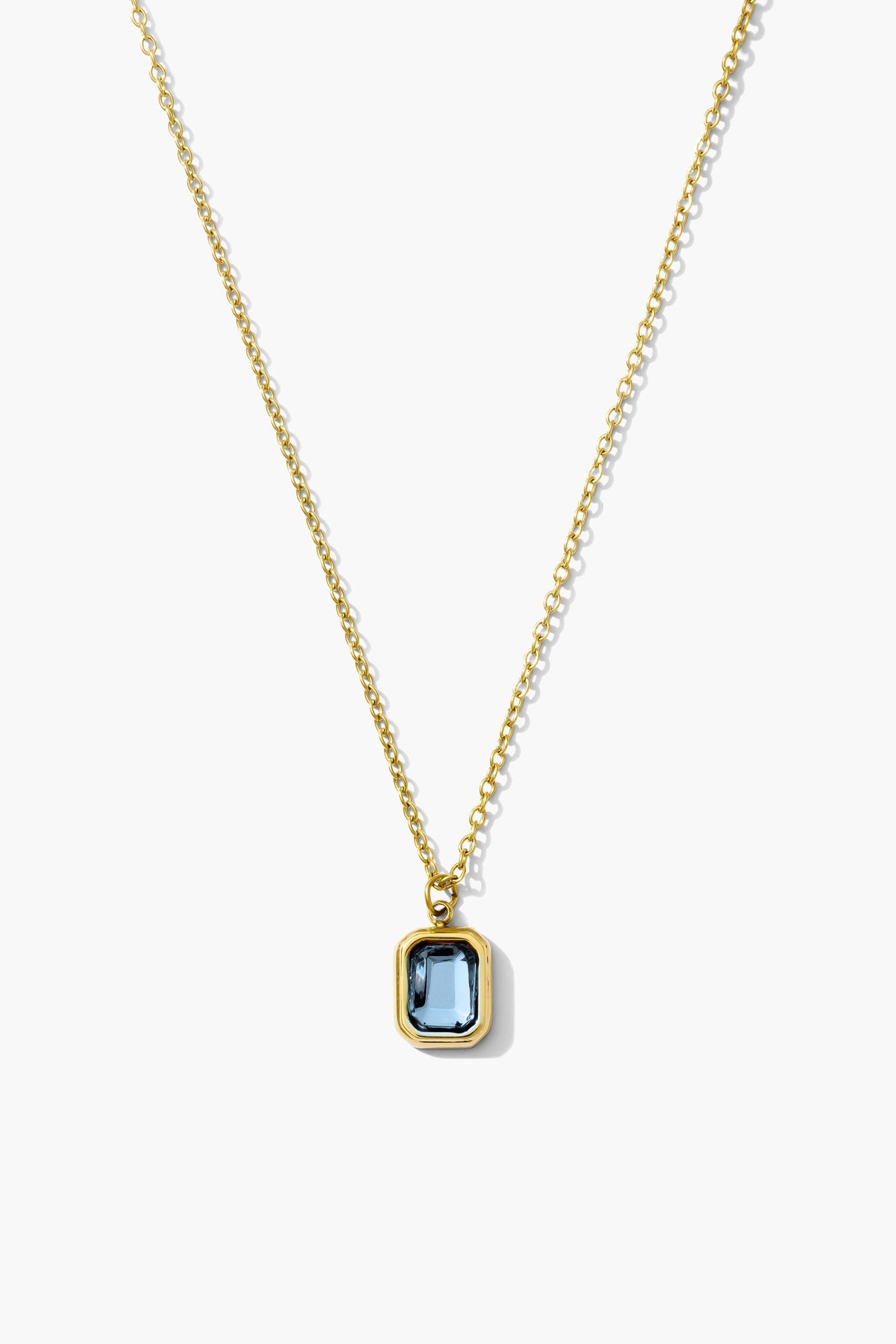 December blue zircon birthstone necklace, turquoise blue emerald-cut stone on an 18K gold plated chain