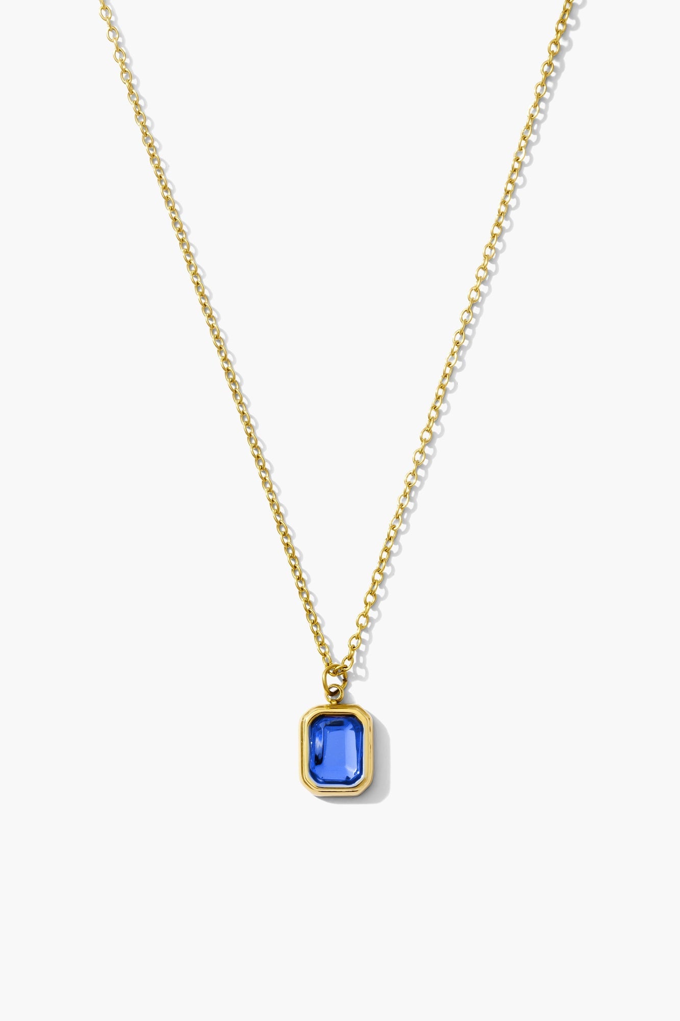 September sapphire birthstone necklace, deep blue emerald-cut stone on an 18K gold plated chain